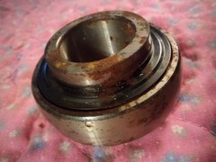 John Deere Bearing. NOS. 1 1/8″ inside diameter. 2 1/4″ outside diameter.